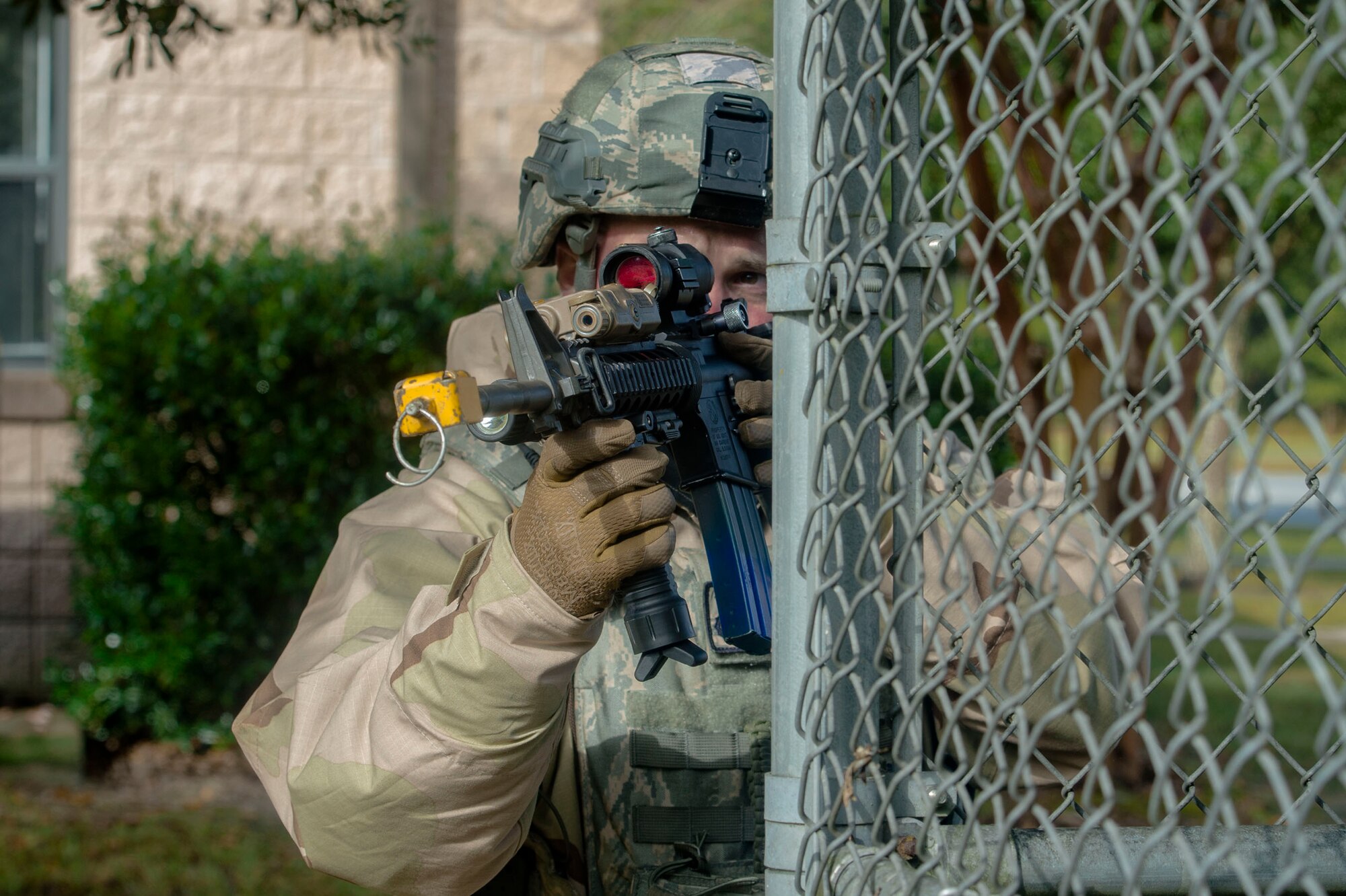 A defender from the 23d Security Forces Squadron fends off mock insurgents during exercise Flying Tigers 19-01C, Nov. 6, 2018, at Moody Air Force Base, Ga. The weeklong event is the second phase of a contingency operation exercise which tests Moody Airmen on their ability to successfully survive in a contested and degraded operational environment while donning mission-oriented protective posture (MOPP) gear. (U.S. Air Force photo by Senior Airman Greg Nash)