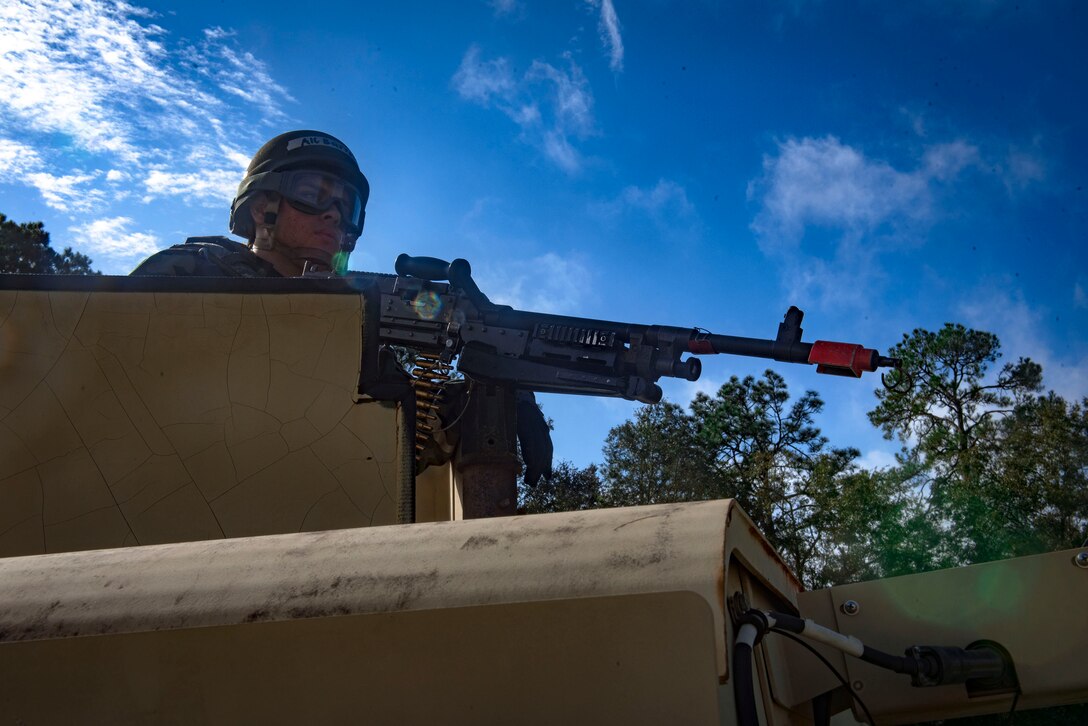 A defender from the 23d Security Forces Squadron scans the perimeter for mock insurgents during exercise Flying Tigers 19-01C, Nov. 6, 2018, at Moody Air Force Base, Ga. The weeklong event is the second phase of a contingency operation exercise which tests Moody Airmen on their ability to successfully survive in a contested and degraded operational environment while donning mission-oriented protective posture (MOPP) gear. (U.S. Air Force photo by Senior Airman Greg Nash)