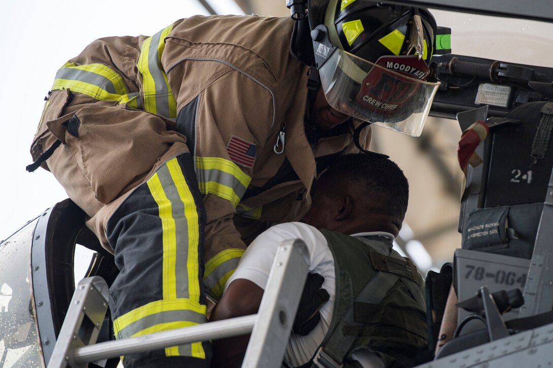 Staff Sgt. Tyler McFarland, 23d Civil Engineer Squadron firefighter, lifts a simulated casualty during an A-10C Thunderbolt II egress exercise, Nov. 5, 2018, at Moody Air Force Base, Ga. The five-day exercise, scheduled to take place Nov. 5-9, will give base personnel an opportunity to experience contingency operations in a contested and degraded combat environment. (U.S. Air Force photo by Senior Airman Janiqua P. Robinson)