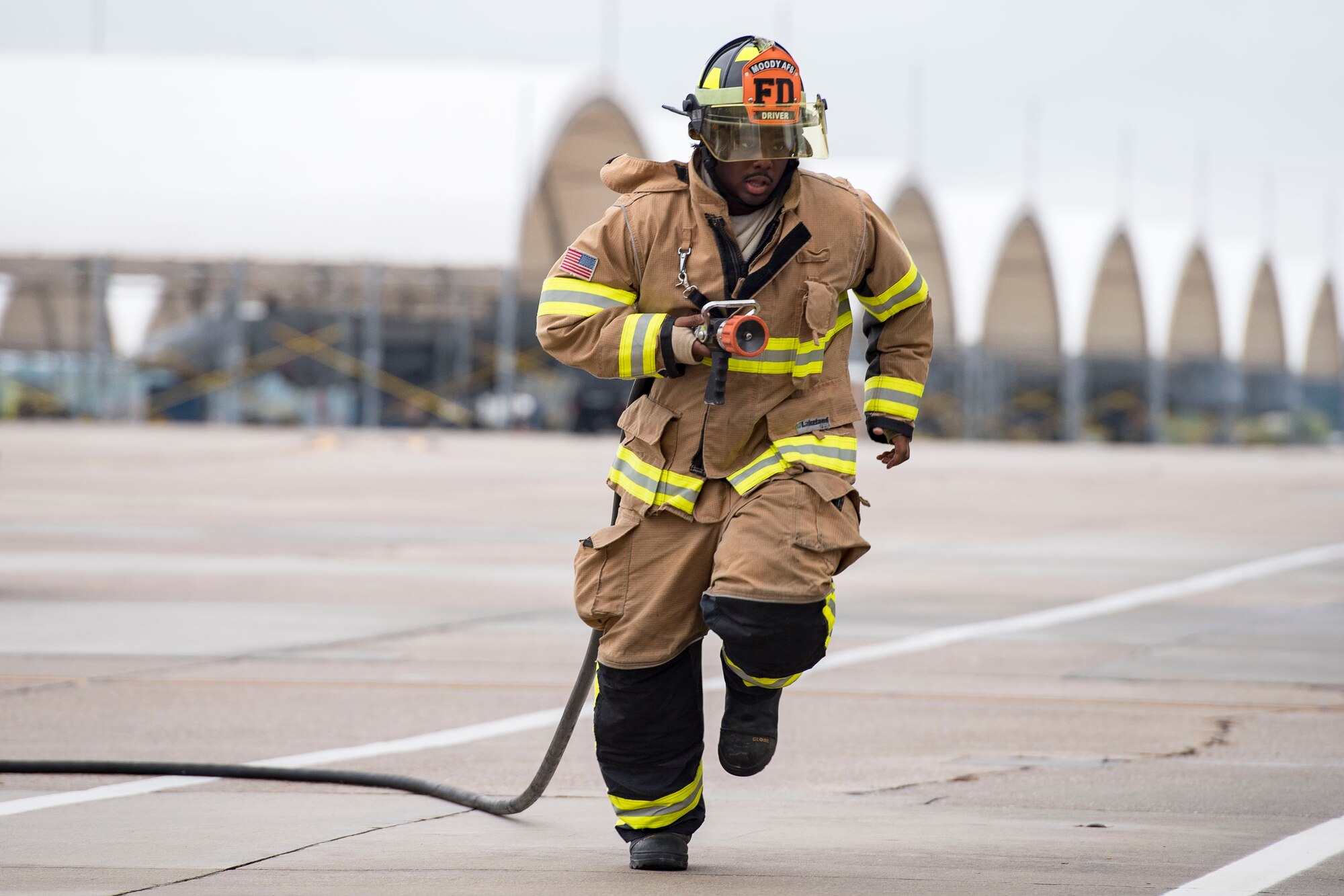 Senior Airman Jeffrey Young, 23d Civil Engineer Squadron firefighter, sprints to a simulated aircraft fire during an A-10C Thunderbolt II egress exercise, Nov. 5, 2018, at Moody Air Force Base, Ga. The five-day exercise, scheduled to take place Nov. 5-9, will give base personnel an opportunity to experience contingency operations in a contested and degraded combat environment. (U.S. Air Force photo by Senior Airman Janiqua P. Robinson)