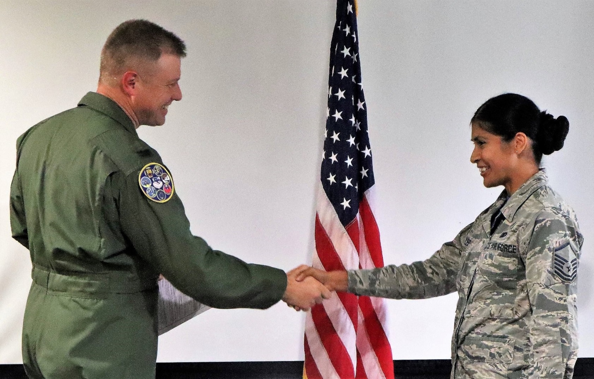 Col. Allen Duckworth, commander of the 340th Flying Training Group, JBSA-Randolph, Texas congratulates to Master Sgt. Jennifer Robles on her reenlistment. U.S. Air Force photo by Janis El Shabazz