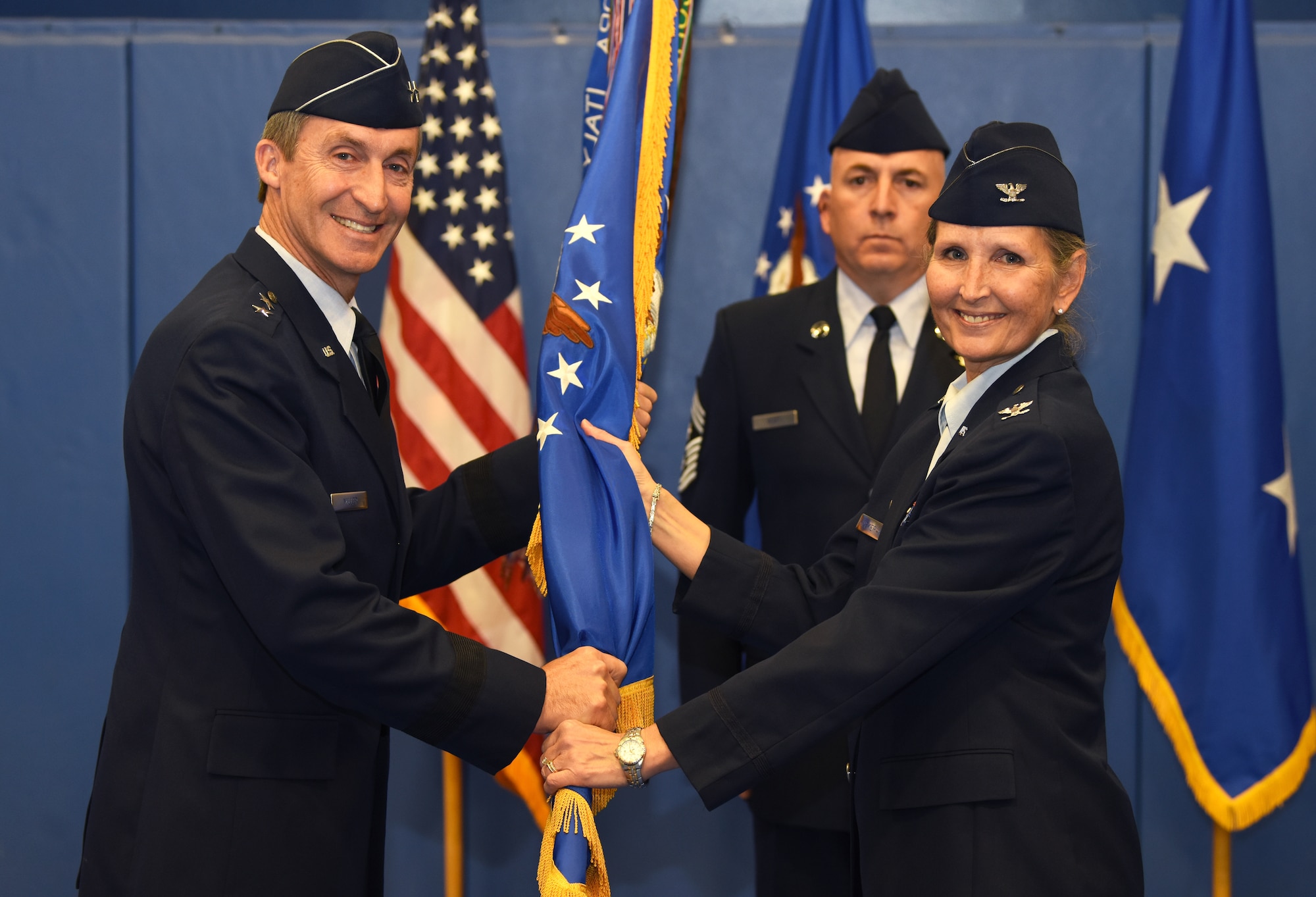 Maj. Gen. Ronald “Bruce” Miller, 10th Air Force commander, receives the 310th Space Wing guidon from Col. Traci L. Kueker-Murphy, outgoing 310th SW commander, during a change of command ceremony, Nov. 3rd, 2018.