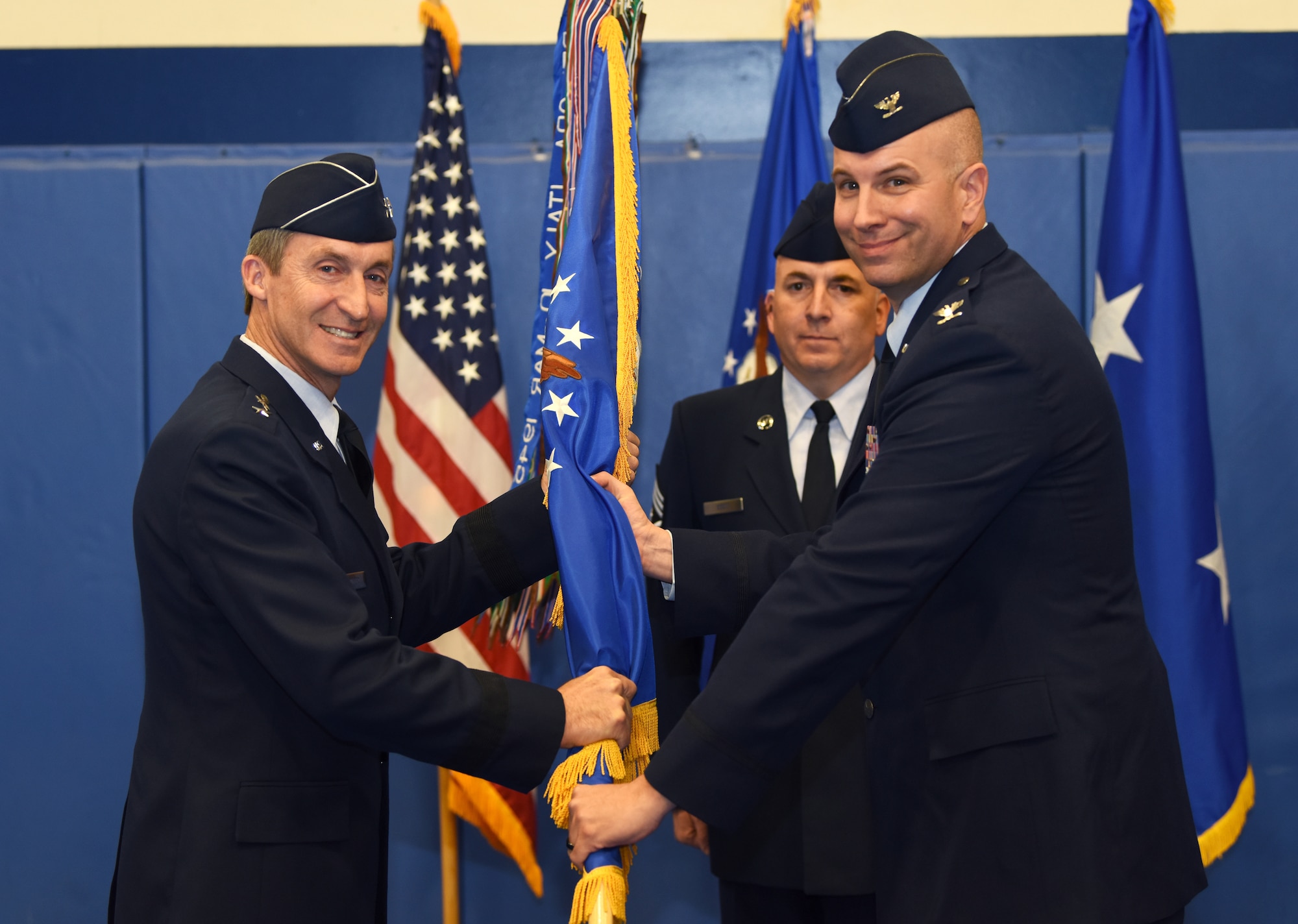 Maj. Gen. Ronald “Bruce” Miller, 10th Air Force commander, hands the 310th Space Wing guidon to Col. Dean D. Sniegowski, incoming 310th SW commander, during a change of command ceremony, Nov. 3rd, 2018.