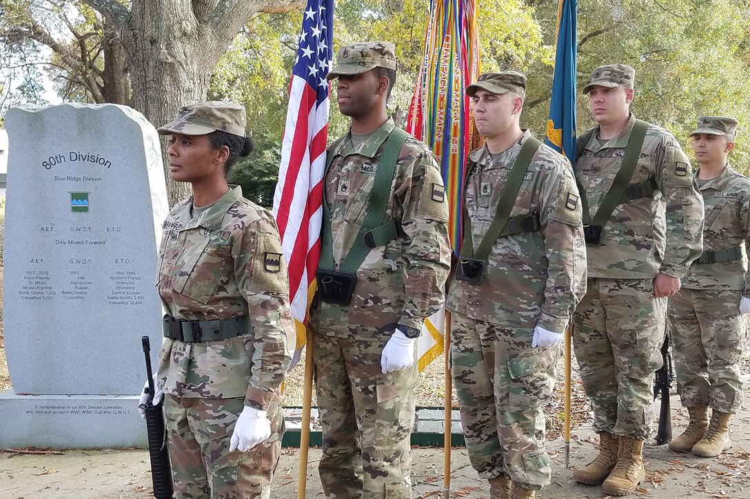 Color guard stands at attention