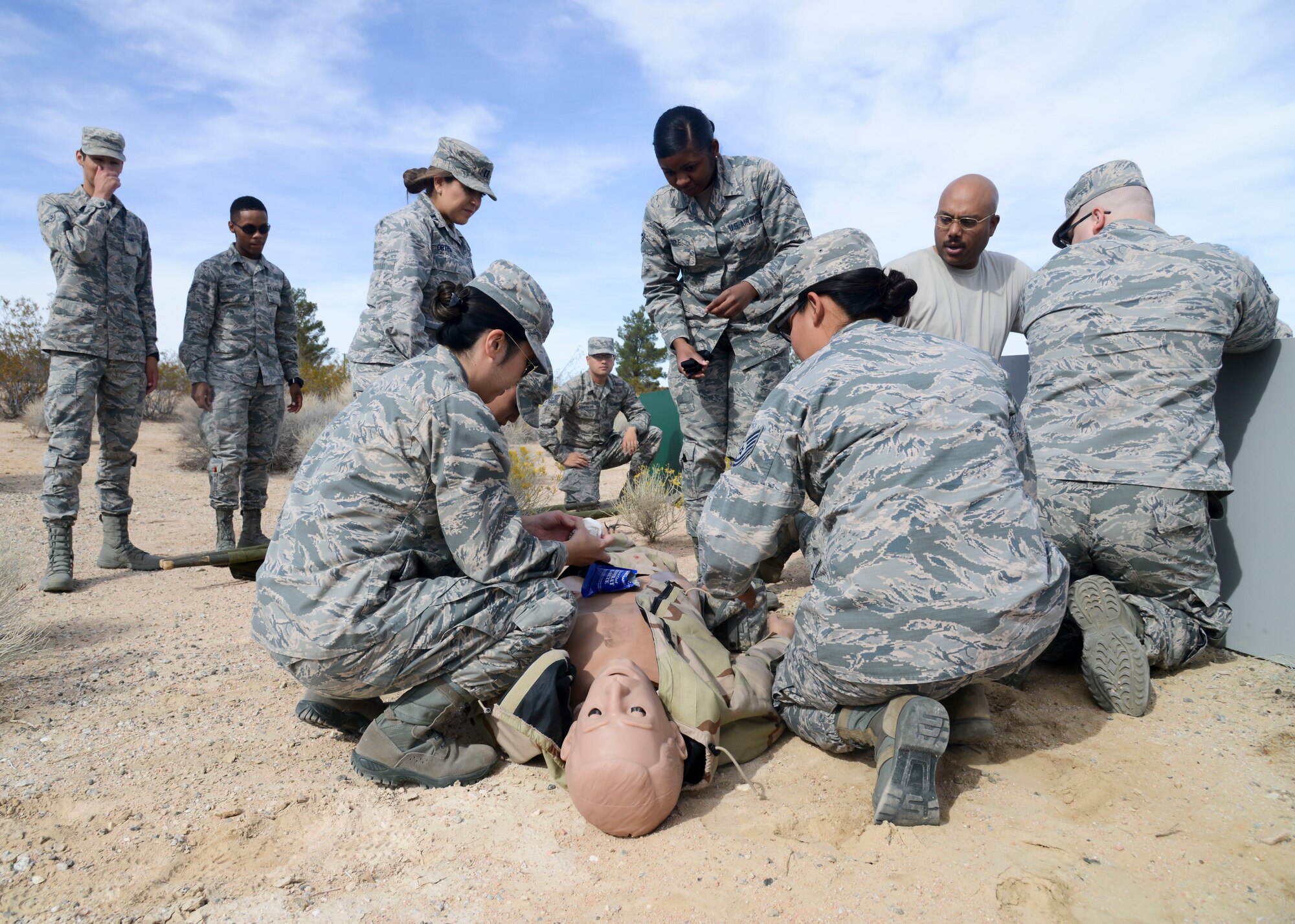 Airmen from the 412th Medical Group provides care under fire for a “victim” during a training exercise at Edwards Air Force Base, California, Nov. 1. The training ensures that Edwards medics are able to provide care in austere conditions. (U.S. Air Force photo by Giancarlo Casem)