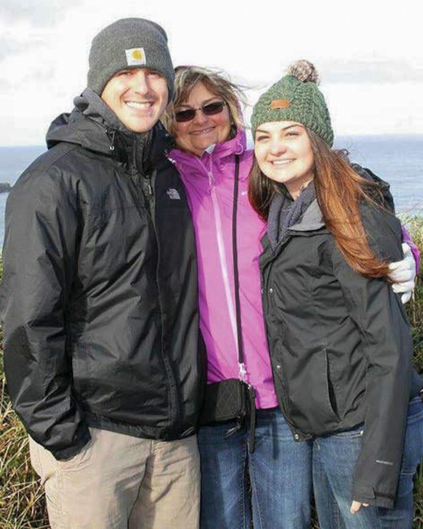 U.S. Air Force Staff Sgt. Taylor Swartz, 22nd Training Squadron Survival Escape Resistance Evasion specialist, poses with his mother Thea Swartz and younger sister Taylor Swartz for a photo. Throughout adolescence into adulthood, Swartz was subjected to the domestic violence of his father toward his mother, sister and himself. (U.S. Air Force photo/Courtesy Photo)