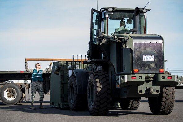 Airman 1st Class Isaac Sanger, 92nd Logistics Readiness Squadron cargo movement specialist, assists in moving cargo for inspection before being loaded onto a KC-135 Stratotanker for transport at Fairchild Air Force Base, Washington, Oct. 17, 2018. The process of a successful cargo transport requires the skills of multiple agencies across the base to ensure an efficient process. (U.S. Air Force photo/Airman 1st Class Whitney Laine)