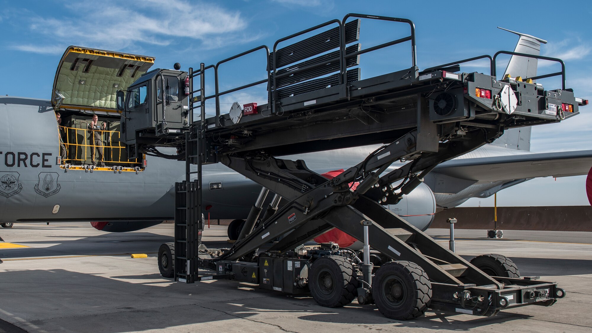 Senior Airman Joshua Lawson, 93rd Air Refueling Squadron boom operator, guides a cargo loader to a KC-135 Stratotanker during a cargo load training at Fairchild Air Force Base, Washington, Oct. 17, 2018. Cargo training gives Airmen a new perspective and helps improve each unit’s understanding of the process and protocols while working as one cohesive team. (U.S. Air Force photo/Airman 1st Class Whitney Laine)