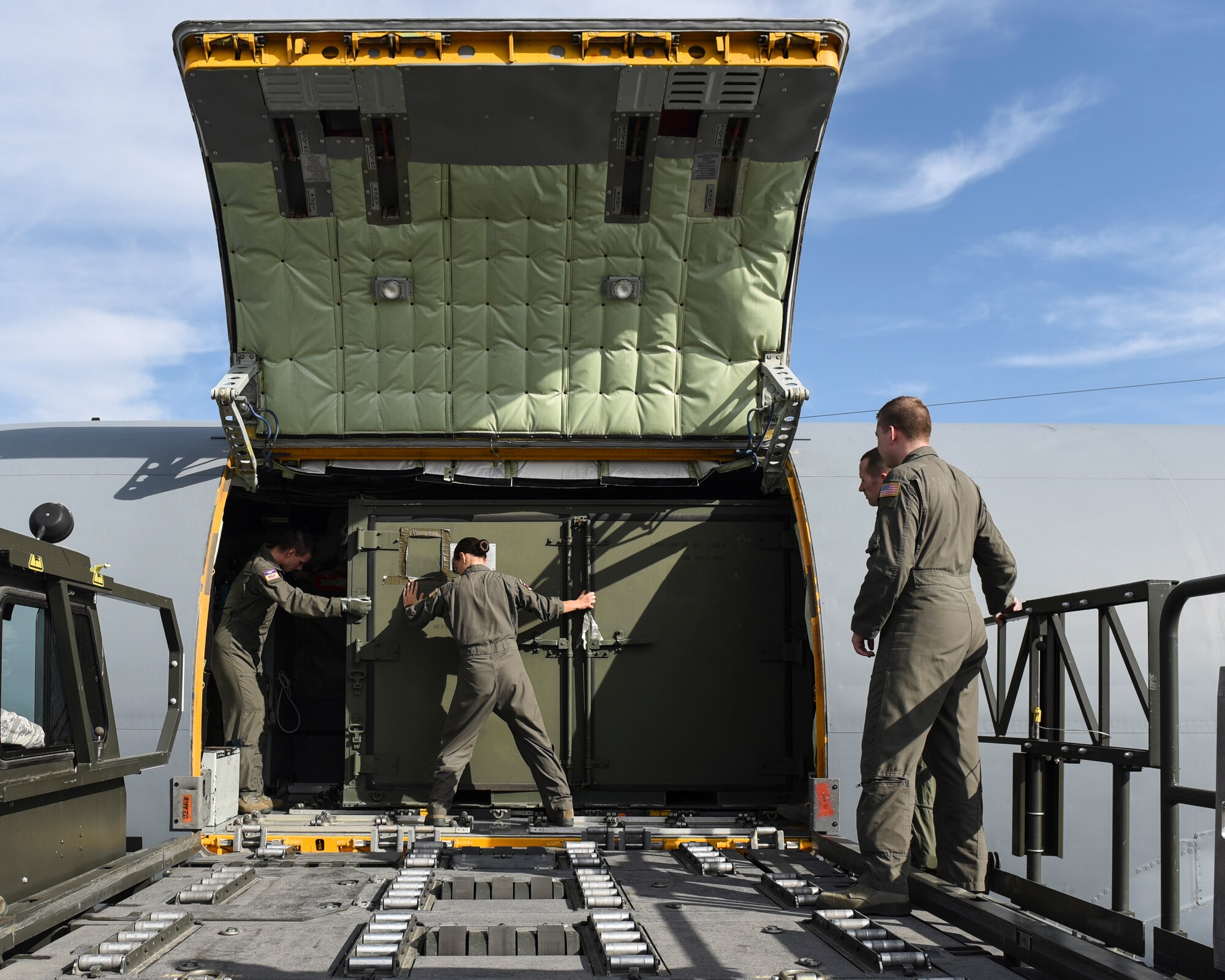 A Team Fairchild aircrew offloads a container from a KC-135 Stratotanker during cargo load training at Fairchild Air Force Base, Washington, Oct. 17, 2018. Cargo training is designed to keep Airmen skillful in executing proper processing and loading procedures. (U.S. Air Force photo/Airman 1st Class Whitney Laine)
