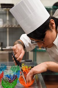 U.S. Army Spc. Abigail Hernandez, a 6th Brigade Engineer Battalion culinary specialist, prepares candy bowls during the grand opening lunch for the Joint Culinary Institute operated at the Gold Rush Inn. JCI is a new bi-monthly, two-week course, providing 10 food-service members from any military branch an opportunity to experience in-depth courses relating to the profession.
