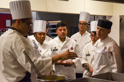 A group of Airmen with the 673d Force Support Squadron and food-service Soldiers from Joint Base Elmendorf-Richardson, Alaska, prepare for the grand opening lunch for the Joint Culinary Institute operated at the Gold Rush Inn. JCI is a new bi-monthly, two-week course, providing 10 food-service members from any military branch an opportunity to experience in-depth courses relating to the profession.