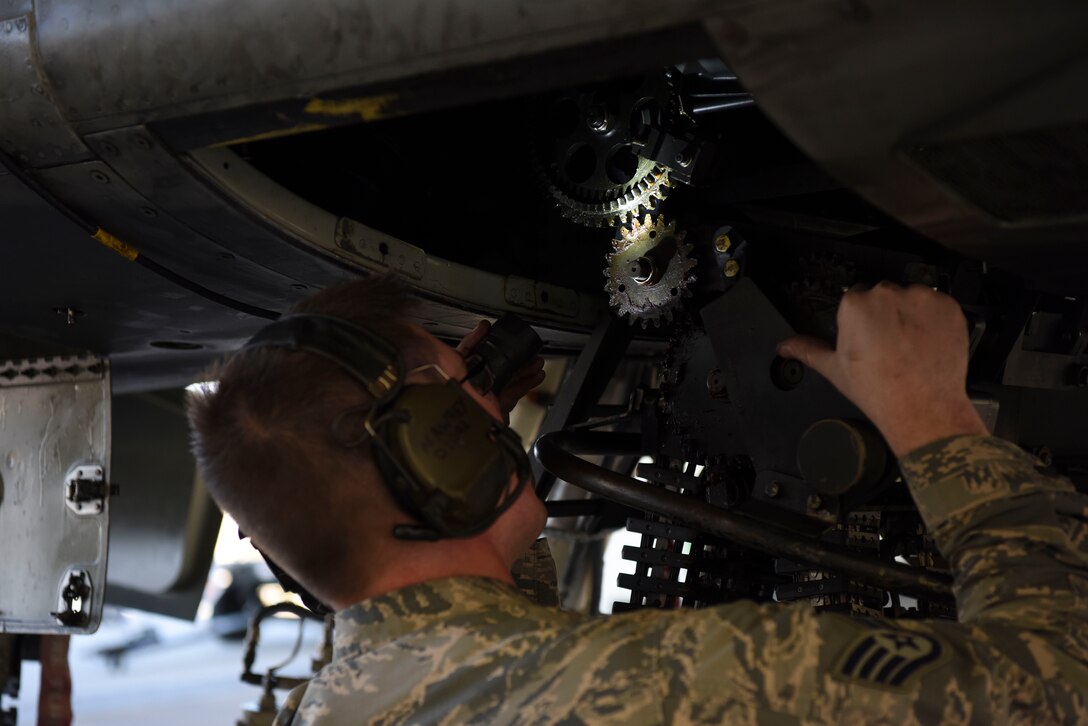 U.S. Air Force Staff Sgt. Nathaniel Awrey, 51st Maintenance Group standardized load crew team lead, ensures that a munitions loader is secured to begin loading at Osan Air Base, Republic of Korea, Nov. 2, 2018. Awrey led his team in the completion of a weapons load during a new loading operation. (U.S. Air Force photo by Airman 1st Class Ilyana A. Escalona)
