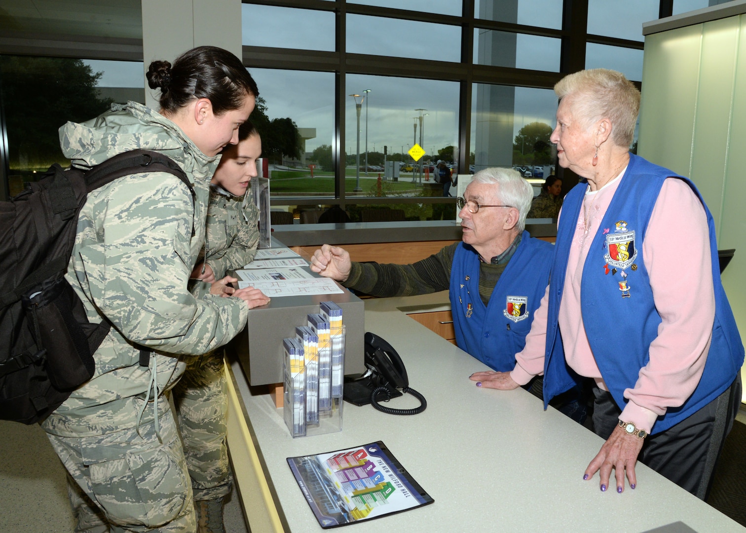 Fred Baker and Viola Calaman, 59th Medical Wing volunteers, assist two Airmen at the A desk in Wilford Hall Ambulatory Surgical Center on Joint Base San Antonio-Lackland, Texas. Volunteers throughout 59th MDW range in age from 18 to 94 and gave more than $1 million in free labor in 2017. 
(U.S. Air Force photo by Daniel J. Calderón)