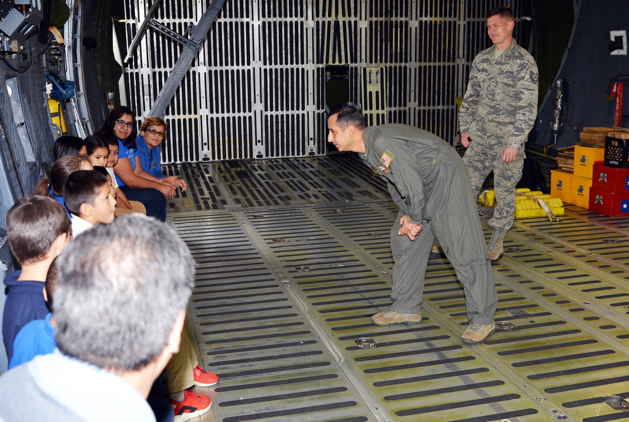 Staff Sgt. Anthony B. Molina, 68th Airlift Squadron flight engineer, listens to a question about the C-5M Super Galaxy from a student with Mildred Baskin Elementary at Joint Base San Antonio-Lackland, Texas Nov. 5, 2018.