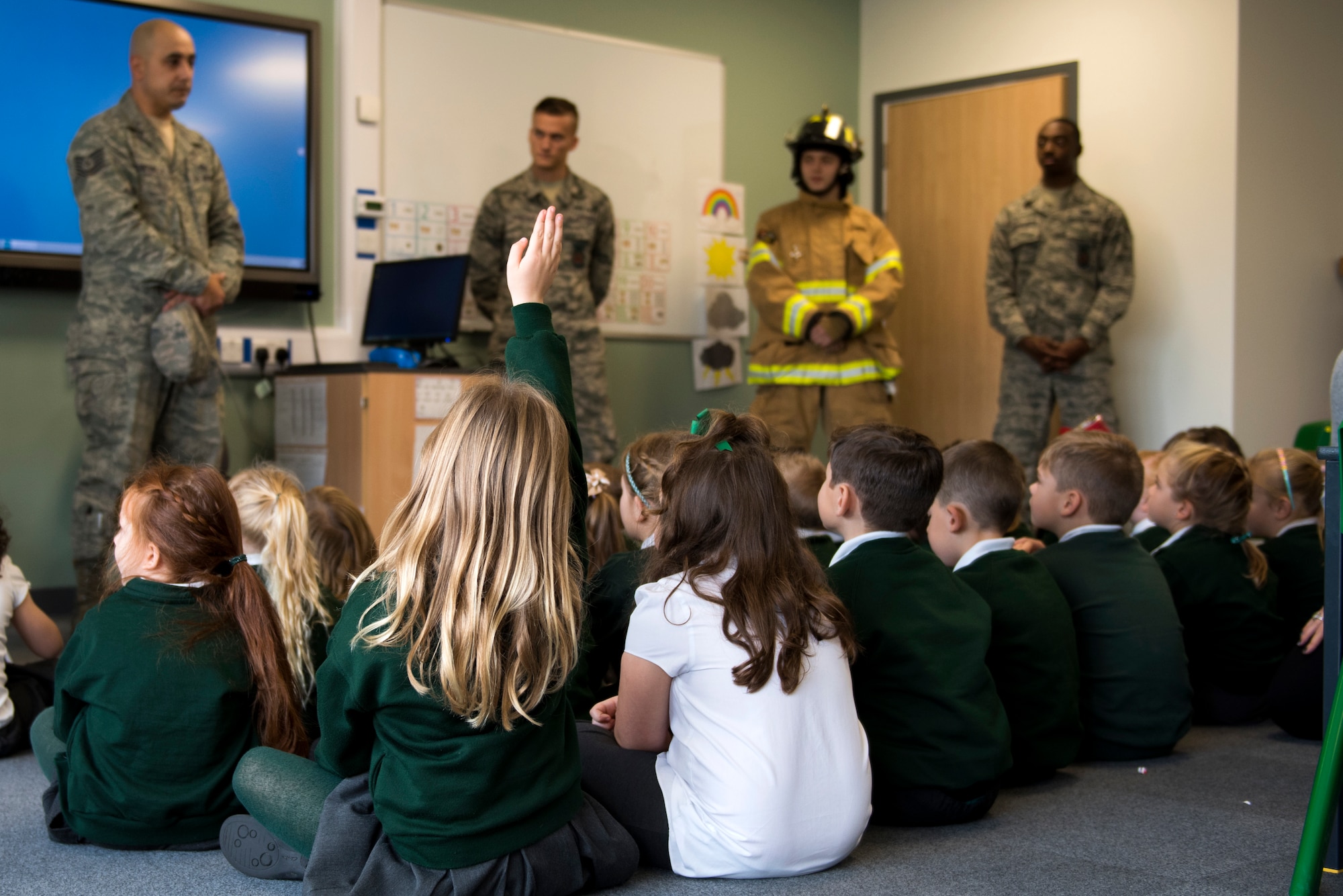 Students from the Pines Primary School listen to 48th Civil Engineer Squadron firefighters during an Everyday Heroes event at Pines Primary School in Red Lodge, England, Nov. 5. Thirty-four children from the newly opened school learned about fire safety and prevention. (U.S. Air Force Photo/ Senior Airman Malcolm Mayfield)