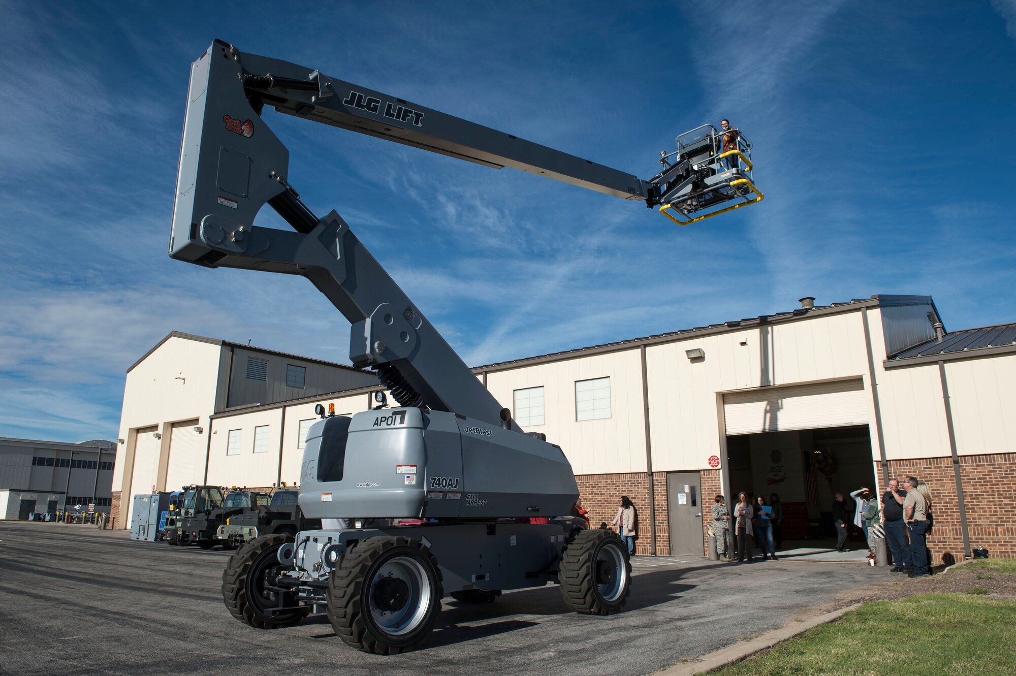 Spouses of members of the 97th Air Mobility Wing look around while on a cherry picker lift during the Heartlink Spouse Orientation