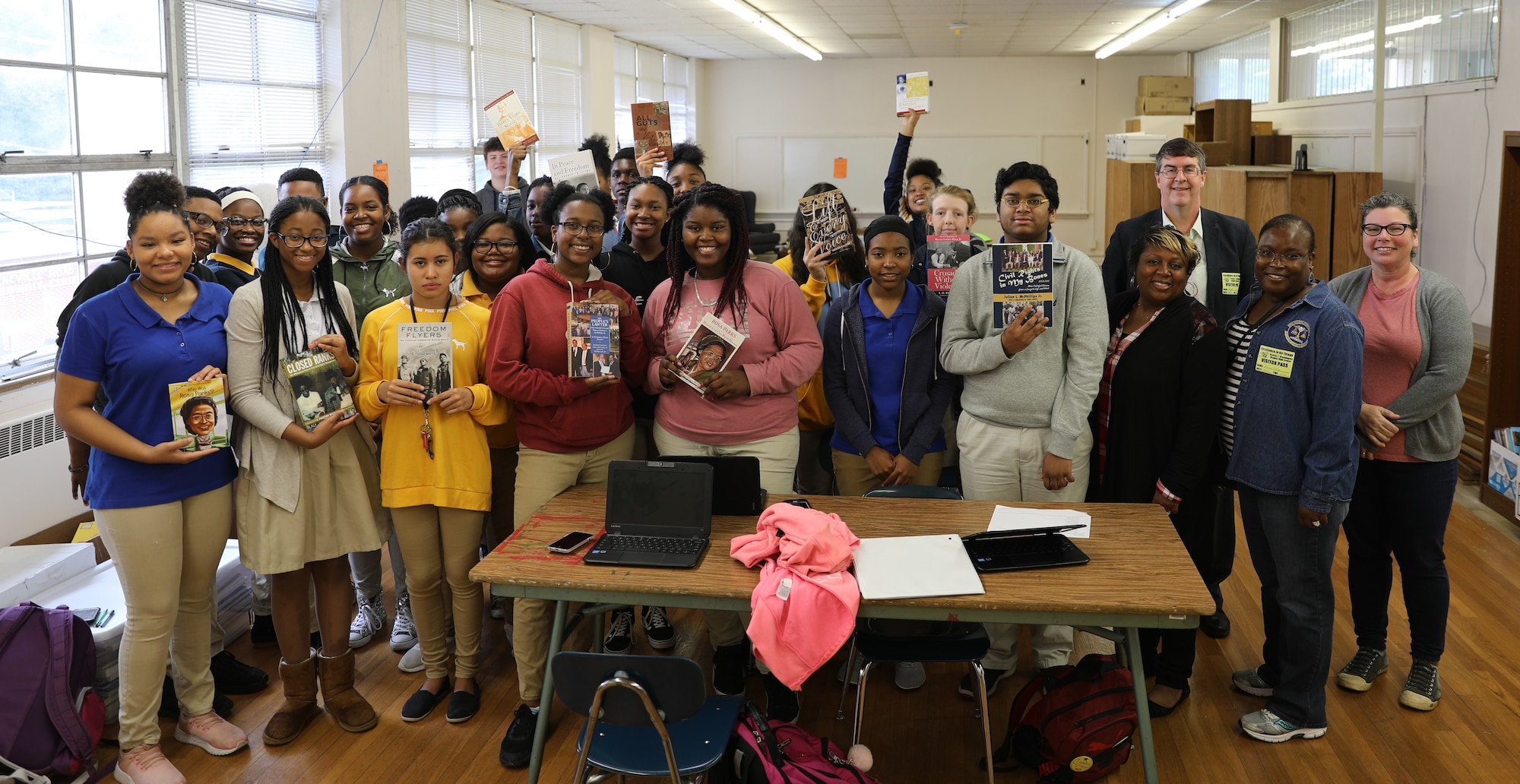 Students at Booker T. Washington Magnet High School receive some of the books donated by the Muir S. Fairchild Research Information Center. On right, Air University library staff Ataya Wallace, Mehmed Ali, Monica Tolver with media specialist Jennifer Sanford. (Courtesy Photo)