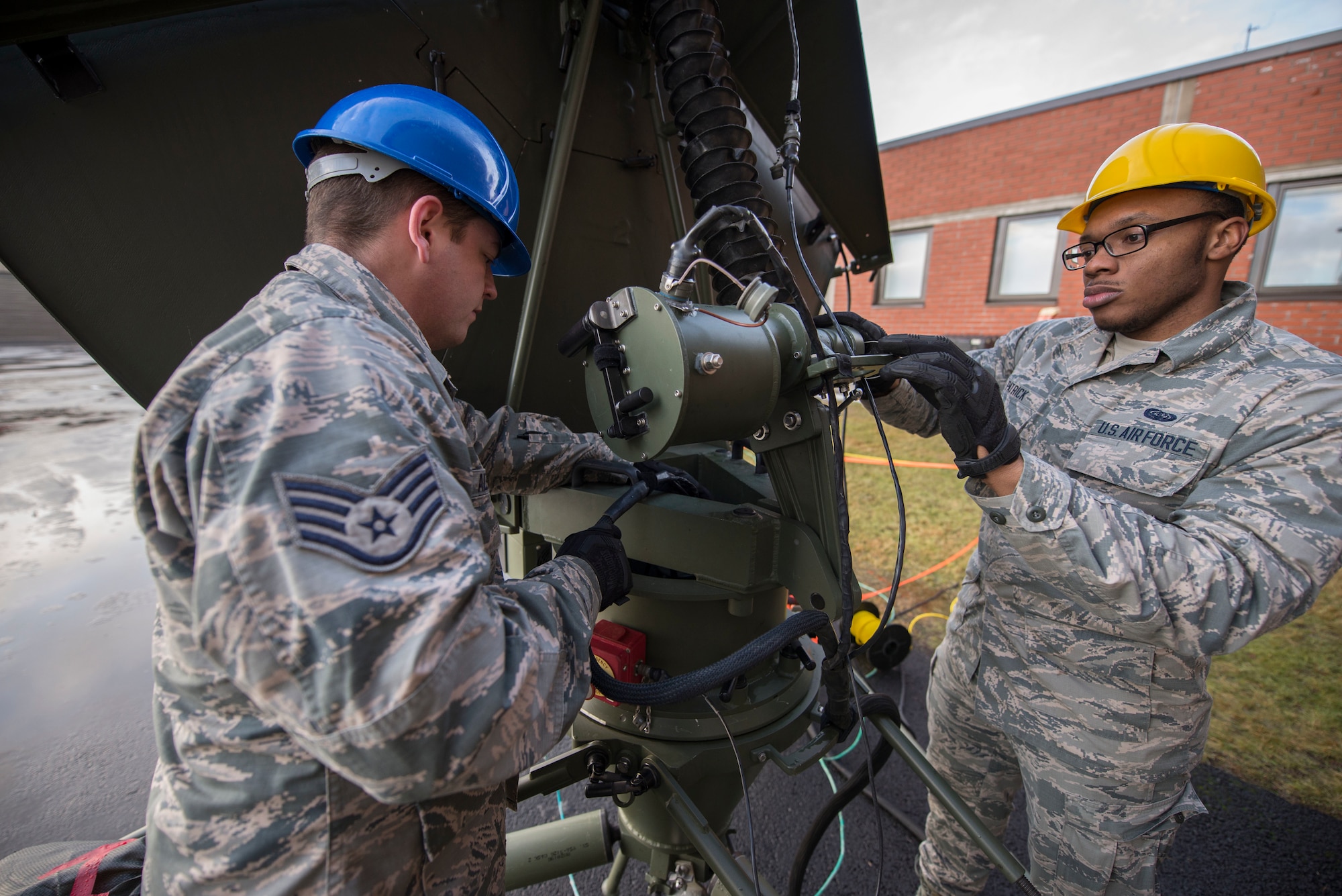 U.S. Air Force Staff Sgt. Charles Alexander, 269th Combat Communications Squadron radio frequency transmissions systems technician, left, and Airman 1st Class Donte Patrick, 1st CBCS radio frequency transmissions systems technician, inspect a satellite antenna for corrosion during Exercise Trident Juncture 18 at Rovaniemi, Finland, Nov. 1, 2018. The exercise increases security by deterring possible threats and enhancing interoperability among NATO allies and partners. (U.S. Air Force photo by Senior Airman Luke Milano)