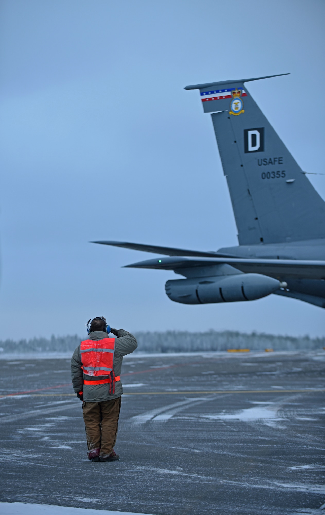 U.S. Air Force Senior Airman Nicholas Vidmar, 100th Aircraft Maintenance Squadron crew chief, salutes after marshalling a U.S. Air Force KC-135 Stratotanker before takeoff to conduct aerial refueling training during Exercise Trident Juncture 18, at Rovaniemi, Finland, Oct. 27, 2018. Trident Juncture is the largest NATO exercise since 2002, with more than 50,000 military members from 31 nations. The U.S. military makes up approximately a quarter of the participating personnel. (U.S. Air Force photo by Senior Airman Luke Milano)