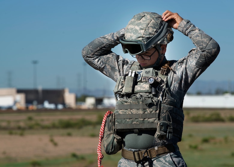 Staff Sgt. Elizabeth Pedroza, 56th Security Forces Squadron military working dog handler, adjusts her personal protective equipment before a joint training exercise at Glendale Municipal Airport Nov. 2, 2018, in Glendale, Ariz.