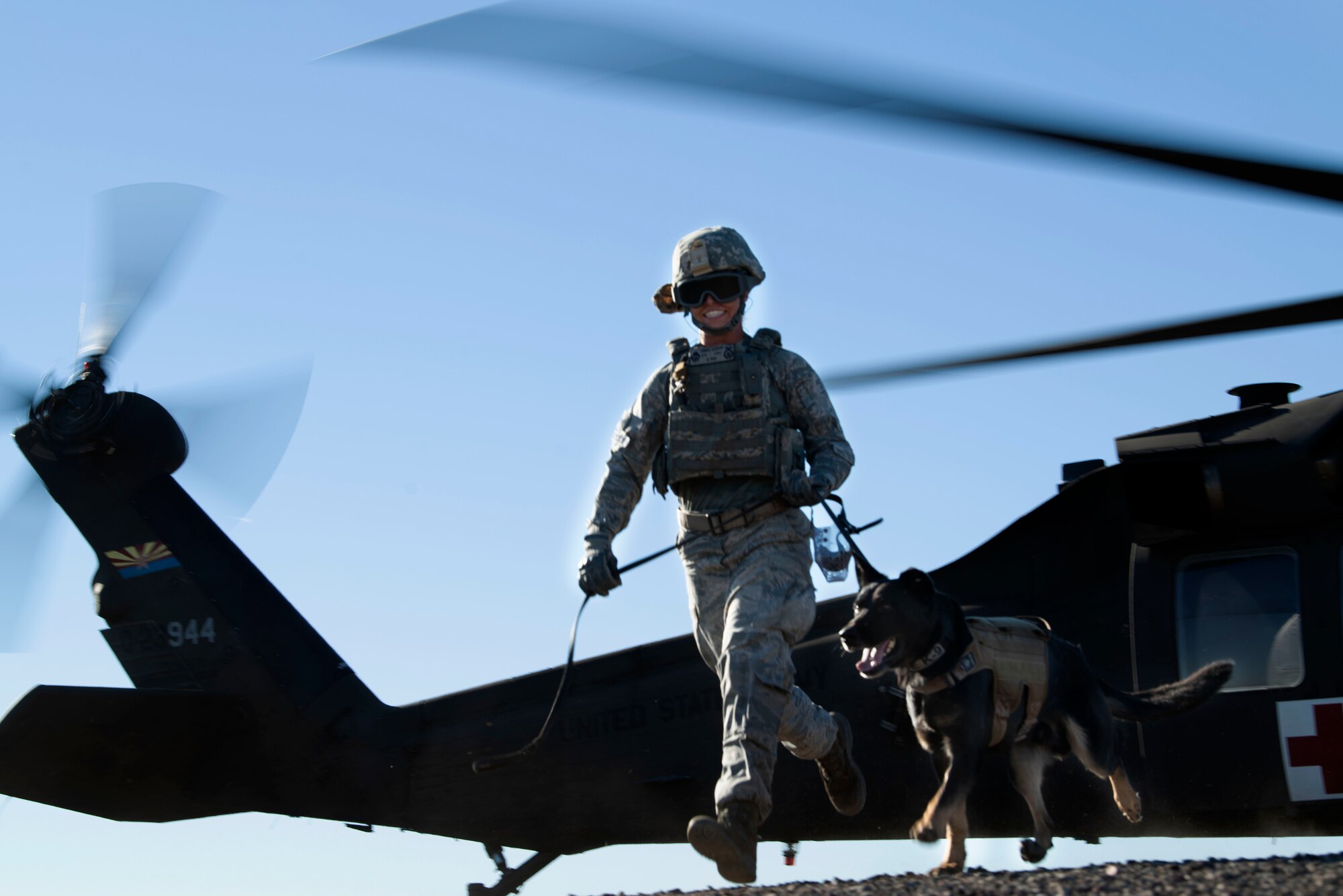 Senior Airman Amber Gordon, 56th Security Forces Squadron military working dog handler, exits a UH-60 Black Hawk after a joint training exercise at Glendale Municipal Airport Nov. 2, 2018, in Glendale, Ariz.