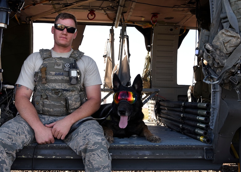Staff Sgt. Kyle Quigg, 56th Security Forces Squadron kennel master, poses for a photo with a 56th SFS military working dog after a joint training exercise at Glendale Municipal Airport Nov. 2, 2018, in Glendale, Ariz.