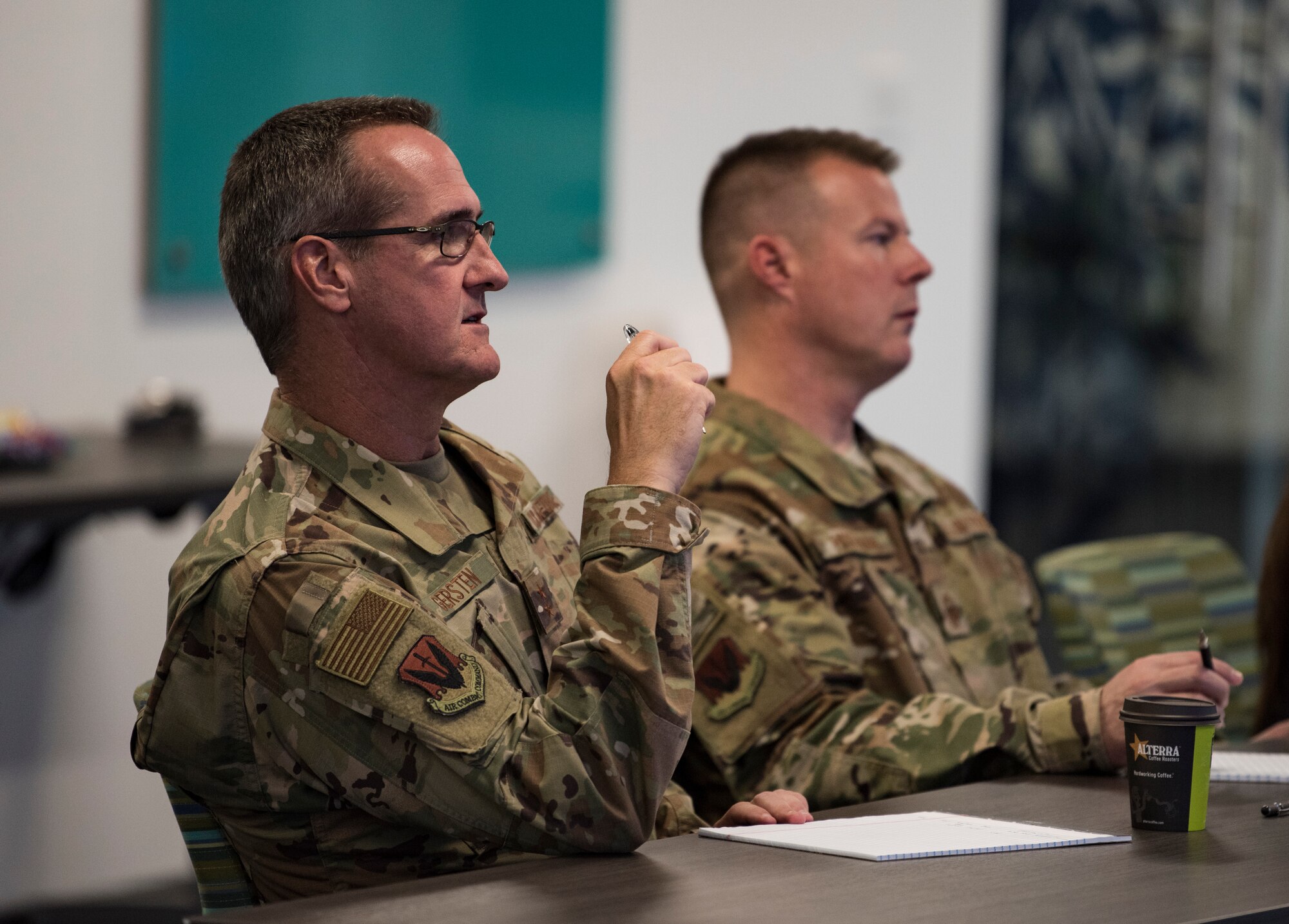 Maj. Gen. Peter Gersten, U.S. Air Force Warfare Center commander, and Chief Master Sgt. Charles Hoffman, USAFWC command chief, listen to an idea presentation Oct. 29, 2018, at AFWERX-Vegas. Gersten and Hoffman listened to seven presentations before selecting two to advance to present at the Air Combat Command competition. (U.S. Air Force photo by Airman 1st Class Andrew D. Sarver)