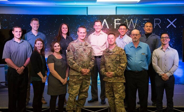 Maj. Gen. Peter Gersten, U.S. Air Force Warfare Center commander, and Chief Master Sgt. Charles Hoffman, USAFWC command chief, stand with members of the Spark Tank prelims at AFWERX-Vegas, Oct. 29, 2018. Seven members presented their ideas to Gersten and Hoffman. Two were selected to move on to present at the Air Combat Command level.