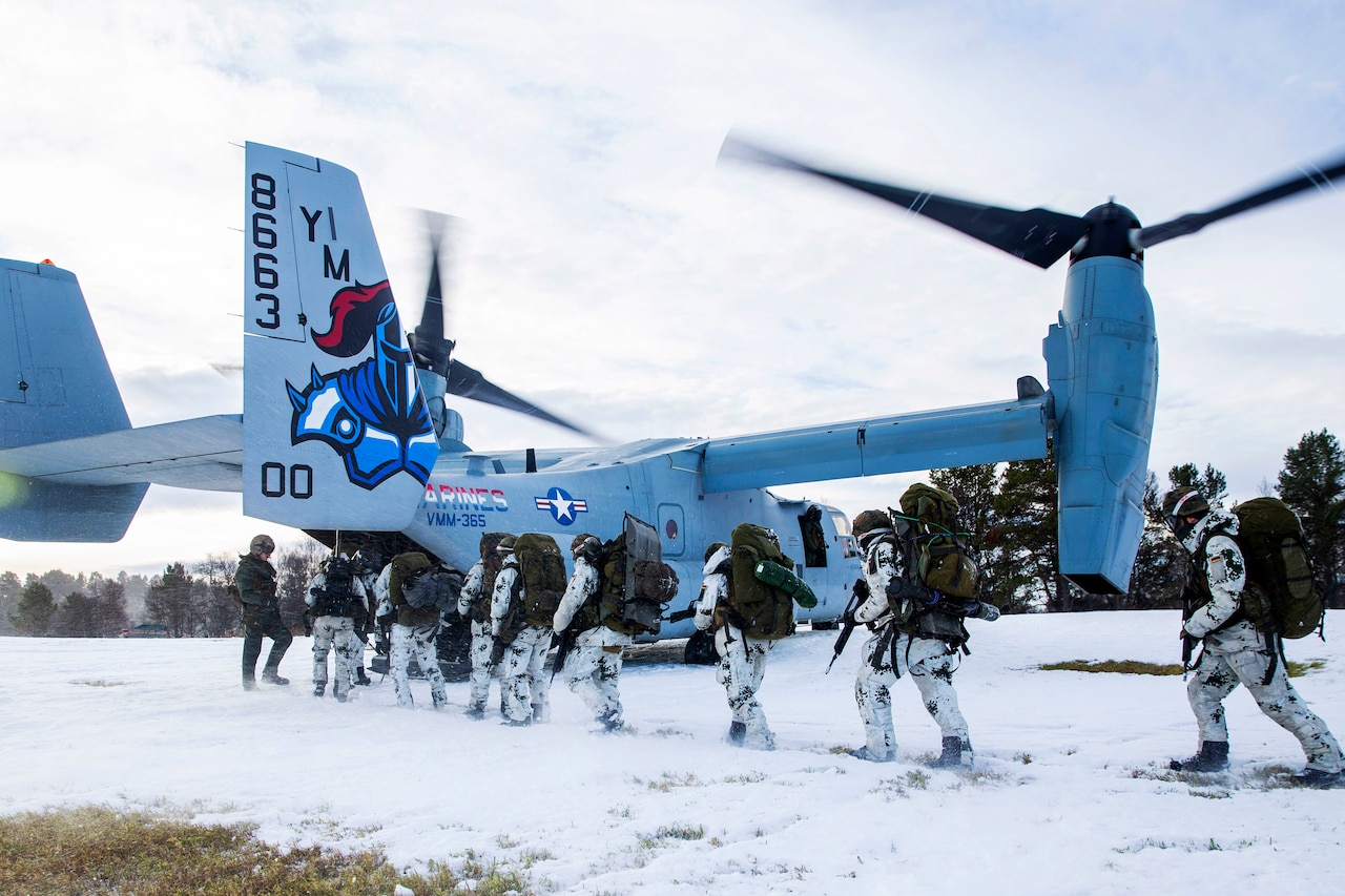 German soldiers board an Osprey.