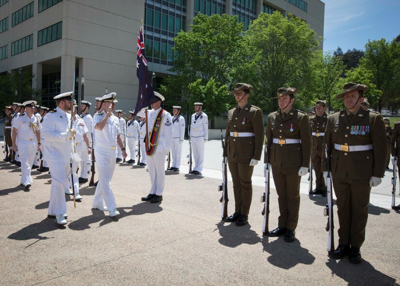 Chief of Naval Operations Adm. John M. Richardson salutes Australian honor guard troops.
