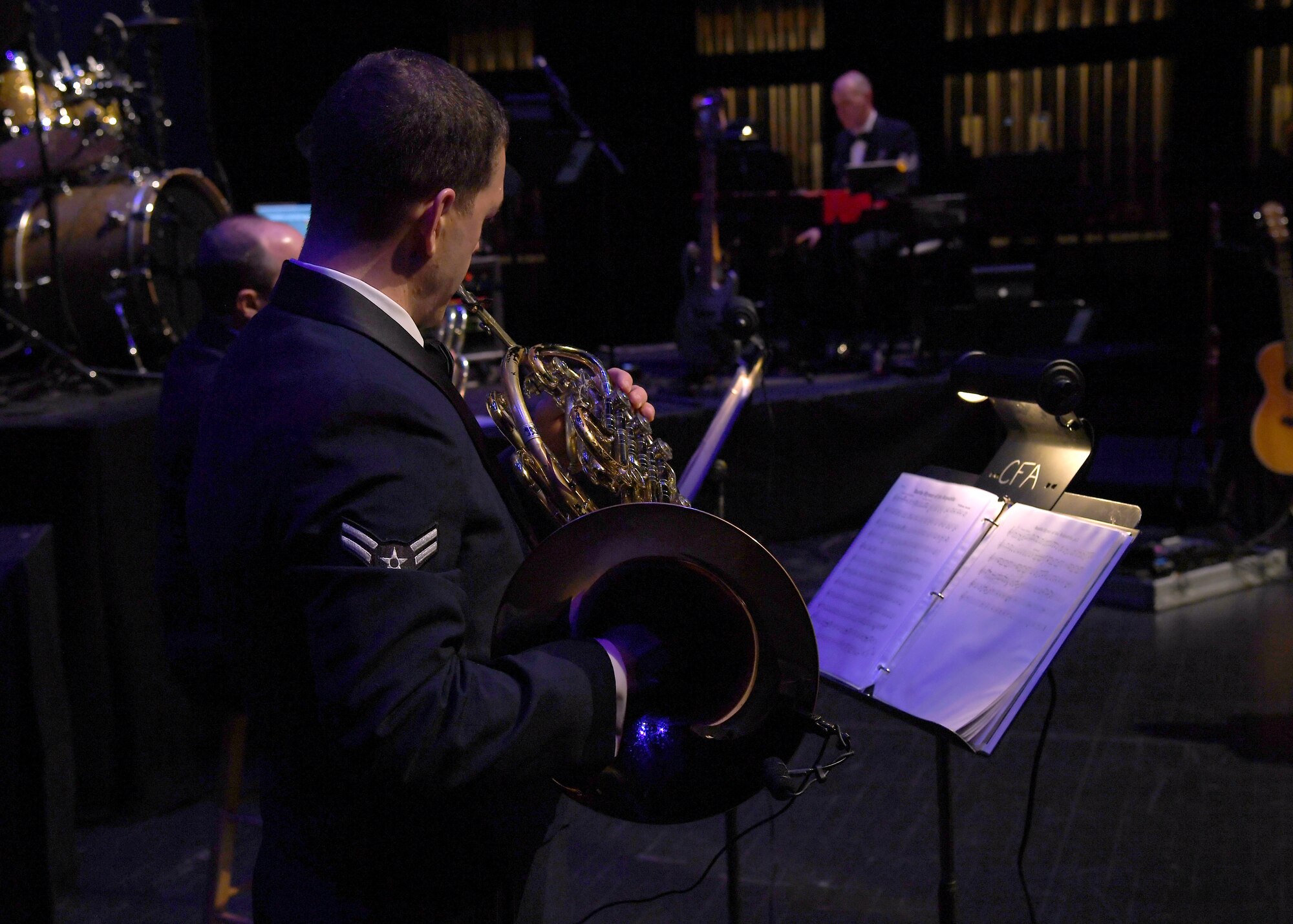 Airman 1st Class Jon Anderson, U.S. Air Force Heartland of America Band French horn player, follows a score as he plays his instrument during a concert at the Chester Fritz Auditorium November 6, 2018, in Grand Forks, North Dakota. The concert was a special veterans Day performance which included a variety of tributes and American classics to include “Amazing Grace,” “America the Beautiful,” and “God Bless America.” (U.S. Air Force photo by Airman 1st Class Elora J. Martinez)
