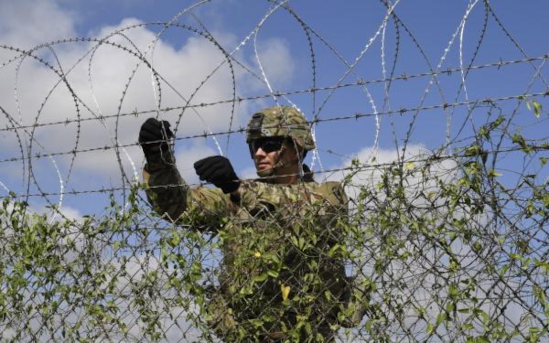 Soldier installs concertina wire in support of CBP