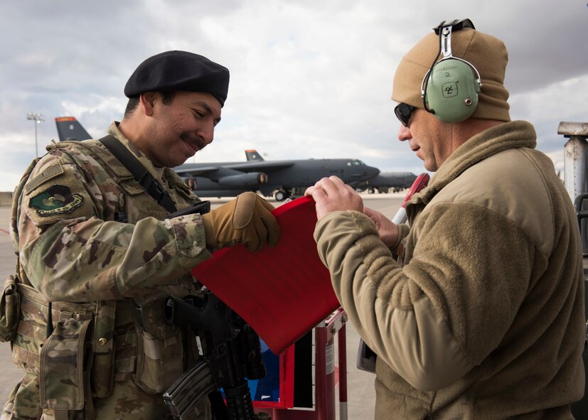 Airman 1st Class Bryan Blancas, 5th Security Forces Squadron defender, checks a flightline access badge during Global Thunder 2019 at Minot Air Force Base, North Dakota, Oct. 30, 2018. Global Thunder is an annual U.S. Strategic Command (USSTRATCOM) exercise designed to provide training opportunities to test and validate command, control and operational procedures. The training is based on a notional scenario developed to drive execution of USSTRATCOM and component forces’ ability to support the geographic combatant commands, deter adversaries and, if necessary, employ forces as directed by the President of the United States. (U.S. Air Force photo by Senior Airman Alyssa M. Akers)