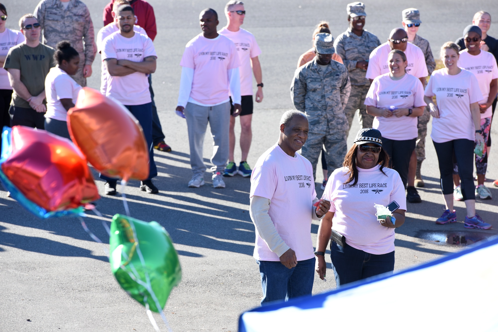 Members of the North Carolina Air National Guard come together during a 1-mile walk/run to support family and friends of recently deceased U.S. Air Force Recruiter Master Sgt. Valanda Pettis. Master Sgt. Pettis’ battle with cancer came to an end this Fall and to honor her memory, the NCANG Recruiting office hosted the Color Run, which involves a 1-mile walk/run with colorful chalk thrown in the air and on participants, to inspire cheer in those she left behind. The theme of the race, “Livin’ my best life,” is a phrase Pettis was often heard singing or using around her loved ones to instill faith, joy, and love.