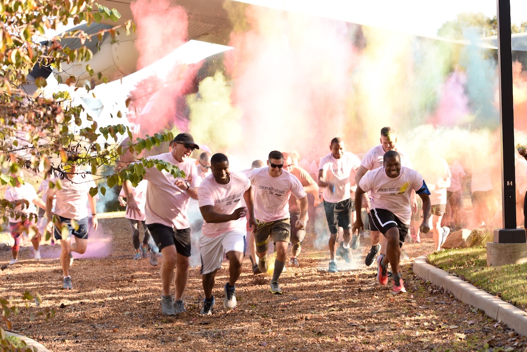 Members of the 145th Airlift Wing, family, and friends take off in a sprint during a ‘Living’ My Best Life’ Color Race, held at the North Carolina Air National Guard (NCANG) Base, Charlotte Douglas International Airport, Nov. 3, 2018. The Color Run, put together by the NCANG Recruiting Office, honors recently deceased U.S. Air Force Recruiter Master Sgt. Valanda Pettis, following her battle with cancer. Master Sgt. Pettis was believed by many to have a colorful personality and would often be heard singing, ‘Livin’ My Best Life,’ during the good and bad days; a true testament to her strength.
