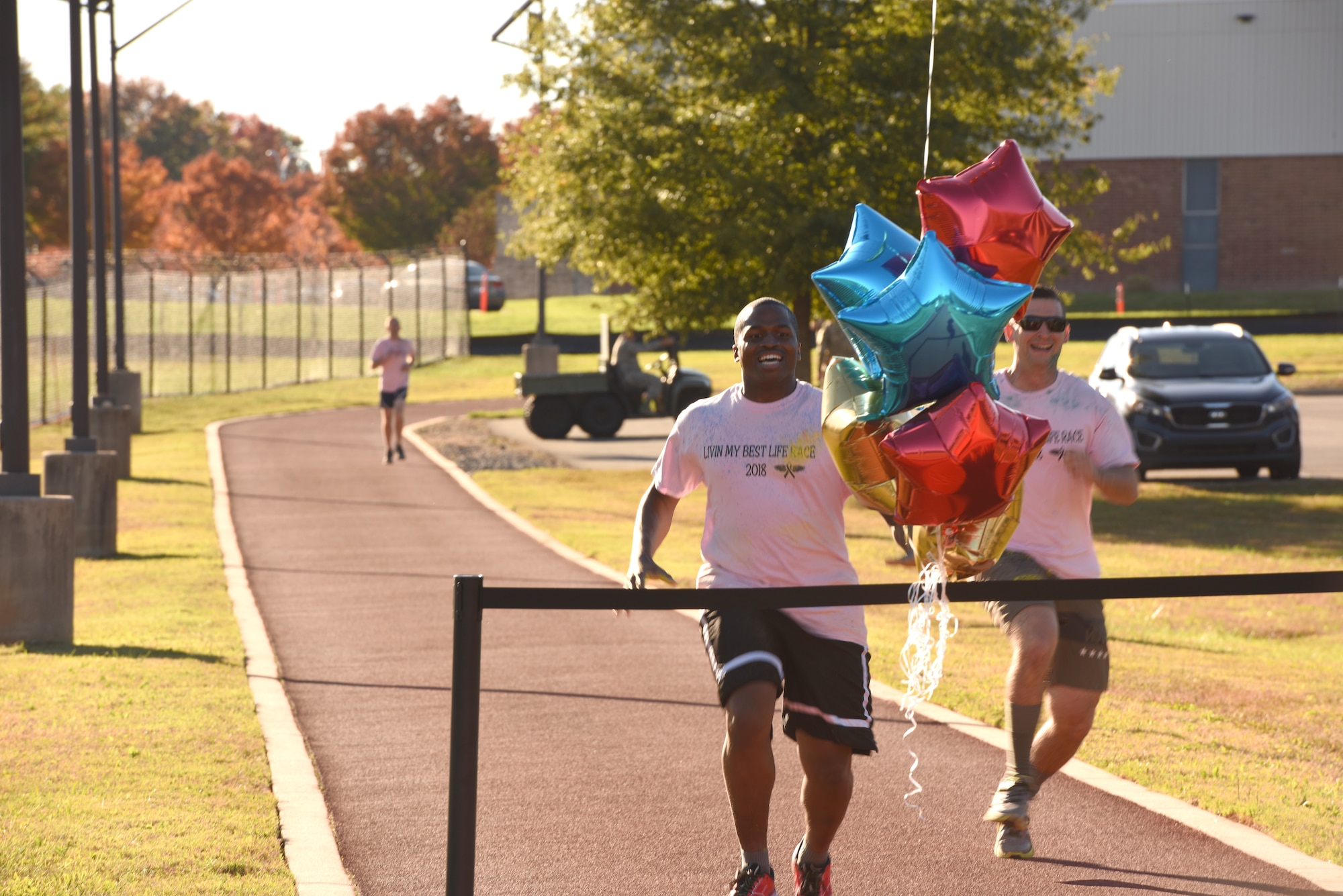 Members of the 145th Airlift Wing, sprint towards the finish line during a ‘Living’ My Best Life’ Color Race, held at the North Carolina Air National Guard (NCANG) Base, Charlotte Douglas International Airport, Nov. 3, 2018. The Color Run, put together by the NCANG Recruiting Office, honors recently deceased U.S. Air Force Recruiter Master Sgt. Valanda Pettis, following her battle with cancer. Master Sgt. Pettis was believed by many to have a colorful personality and would often be heard singing, ‘Livin’ My Best Life,’ during the good and bad days; a true testament to her strength.