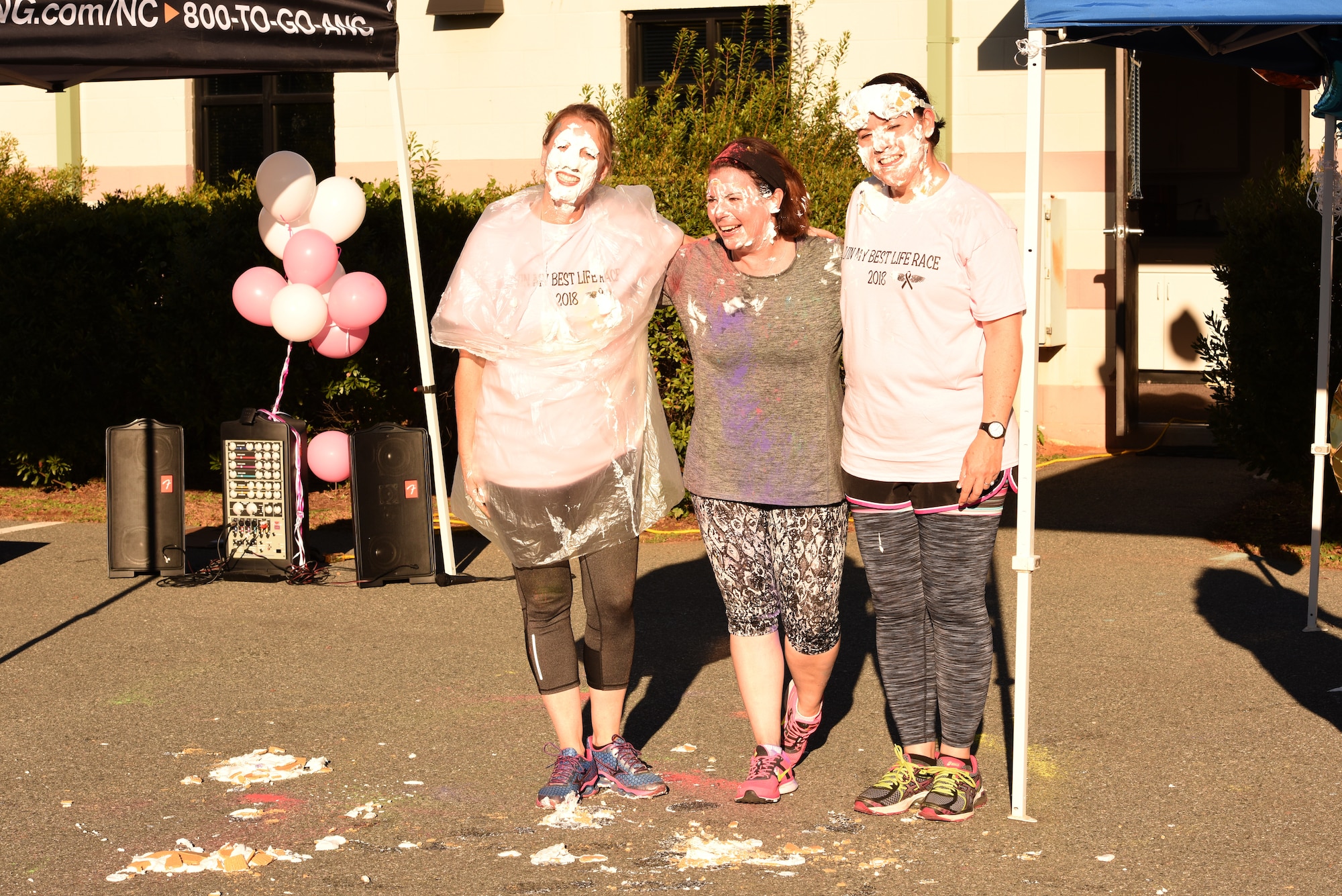 U.S. Air Force Col. Bryony A. Terrell, 145th Airlift Wing commander (left), Lt. Col. Lisa Kirk, 145th Mission Support Group commander (center), and Lt. Col. Karen Shook, 145th Maintenance Group commander (right), pose together after being pied in the face for a fundraising event following a ‘Living’ My Best Life’ Color Race, held at the North Carolina Air National Guard (NCANG) Base, Charlotte Douglas International Airport, Nov. 3, 2018. The Color Run, put together by the NCANG Recruiting Office, honors recently deceased U.S. Air Force Recruiter Master Sgt. Valanda Pettis, following her battle with cancer. Master Sgt. Pettis was believed by many to have a colorful personality and would often be heard singing, ‘Livin’ My Best Life,’ during the good and bad days; a true testament to her strength.