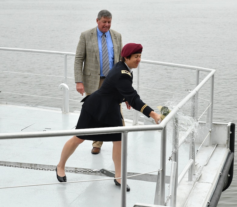 Maj. Brooke Henderson, U.S. Army Reserves, christens Survey Vessel Damrell as Bubba Poiroux, Supervisory Civil Engineer U.S. Army Corps of Engineers Mobile District, looks during the ceremony Nov. 8, 2018, at the Cooper Riverside Park Amphitheater in Mobile, Ala. The Damrell is named after Col. Andrew N. Damrell — the first and longest serving commander in Mobile District.  Henderson is his great-great granddaughter.