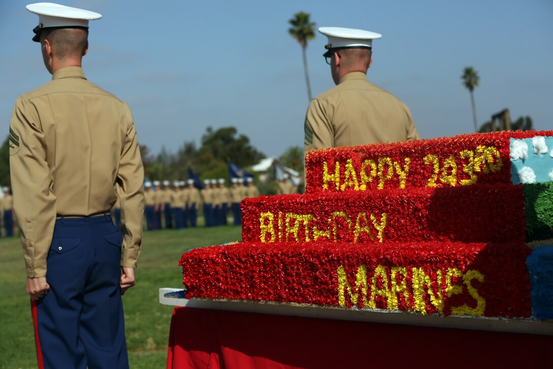 Marines stand at attention during the National Anthem beside the Marine Corps Air Station Miramar 243rd Marine Corps birthday cake at MCAS Miramar, Calif., Nov. 7. Marines with 3rd Marine Aircraft wing and MCAS Miramar celebrated the 243rd Marine Corps birthday with a cake cutting ceremony. (U.S. Marine Corps photo by Sgt. Jake McClung)