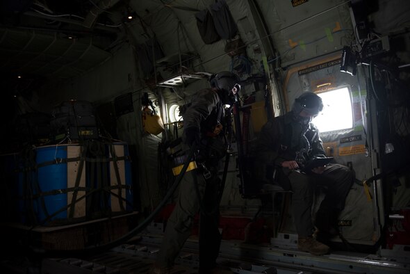 Image of C-130J Super Hercules loadmasters SGT Penny and SGT Lambeth prepare to drop GPS-guided cargo from a C-130J at Saylor Creek Range, Idaho, Nov. 1, 2018. The cargo uses a joint-precision aero-delivery system that guides it to a programmed destination. (U.S. Air Force photo by Senior Airman Alaysia Berry)