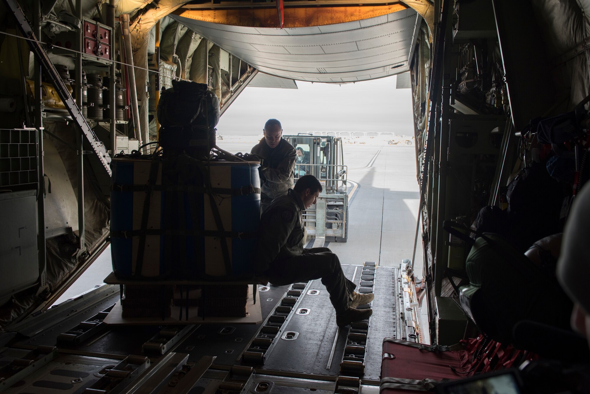 Image of Australian military members load cargo on a C-130J Super Hercules before a flight at Mountain Home Air Force Base, Idaho, Nov. 1, 2018. They visited Mountain Home to perform training scenarios at Saylor Creek Range. (U.S. Air Force photo by Senior Airman Alaysia Berry)