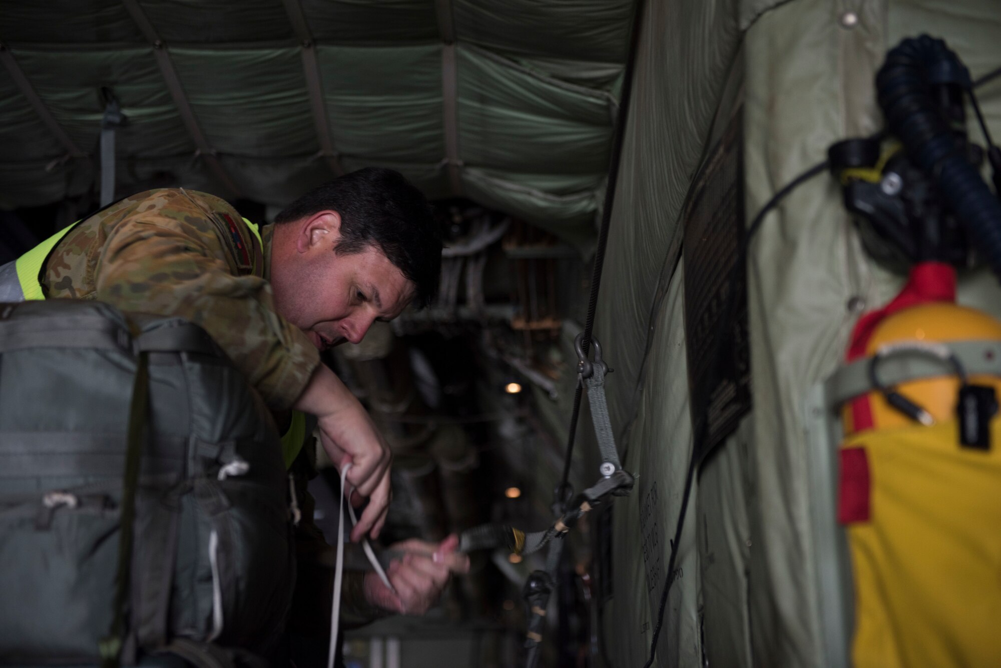 Image of WO2 Hawkins, Australian Army air dispatcher, straps down cargo on a C-130J Super Hercules before a flight Nov. 1, 2018, at Mountain Home Air Force Base, Idaho. One reason members of the Royal Australian Air Force chose to come to Mountain Home AFB is to perform pilot training in extremities against simulated threats to receive various qualifications. (U.S. Air Force photo by Senior Airman Alaysia Berry)