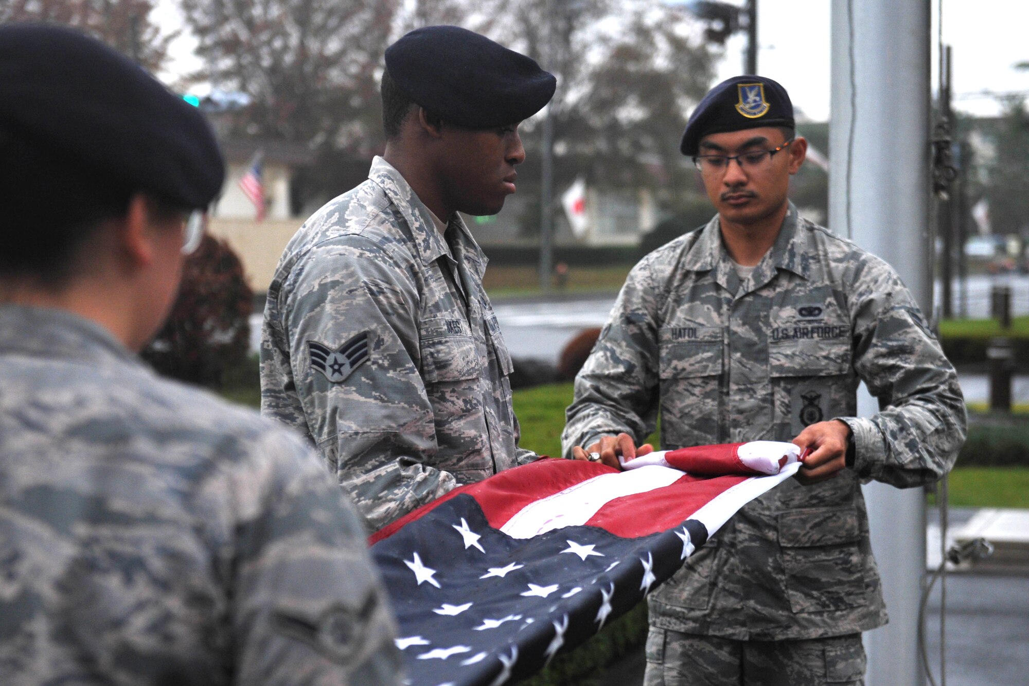 A flag detail from the 374th Security Forces Squadron folds the flag during a Veterans Day ceremony at Yokota Air Base, Japan, Nov. 9, 2018.