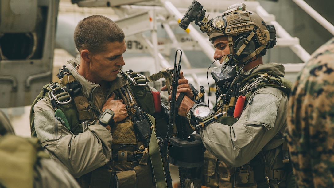 Marines with the Maritime Raid Force, 11th Marine Expeditionary Unit, complete gear checks for a night high-altitude high-opening parachute operation during Realistic Urban Training Exercise at Marine Corps Air Station Yuma, Ariz., Nov. 6, 2018. RUT is the final shore based exercise the 11th MEU will complete during their pre-deployment training cycle in preparation for deployment next year.