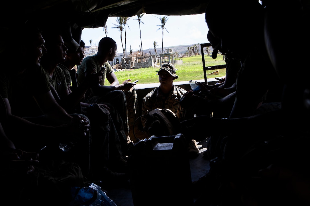 Marines with Combat Logistics Battalion 31 sit in the rear of a 7-ton flatbed truck while delivering U.S. Federal Emergency Management-provided shelter tents as part of U.S. Defense Support of Civil Authorities relief efforts on Tinian, Commonwealth of the Northern Mariana Islands, Nov. 9, 2018. Marines and Sailors with the 31st Marine Expeditionary Unit and CLB-31 are assisting local and civil authorities on Tinian to deliver FEMA shelters for families affected by Super Typhoon Yutu, which struck here Oct. 25 as the second strongest storm to ever hit U.S. soil. Marines and Sailors with the 31st MEU and CLB-31 arrived on Tinian Oct. 29-31 to lead relief efforts on Tinian in response to Yutu as part of Task Force-West. TF-W is leading the Department of Defense’s efforts to assist CNMI’s local and civil authorities provide critical assistance for citizens devastated by Yutu. The 31st MEU, the Marine Corps’ only continuously forward-deployed MEU, provides a flexible force ready to perform a wide-range of military operations across the Indo-Pacific region.