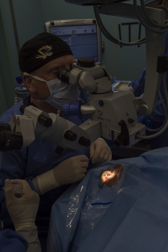 Dr. John Jarstead, an ophthalmologist from the University of Missouri, performs cataract surgery on a patient in an operating room aboard the hospital ship USNS Comfort (T-AH 20).