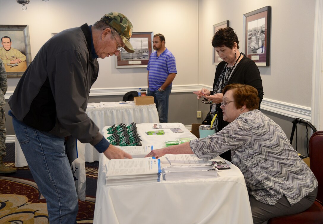 Jerry Shurley receives TRICARE information from Karen Rein, center, and Sharlene Payne during the Retiree Appreciation Day Nov. 3 at the Tinker Club.