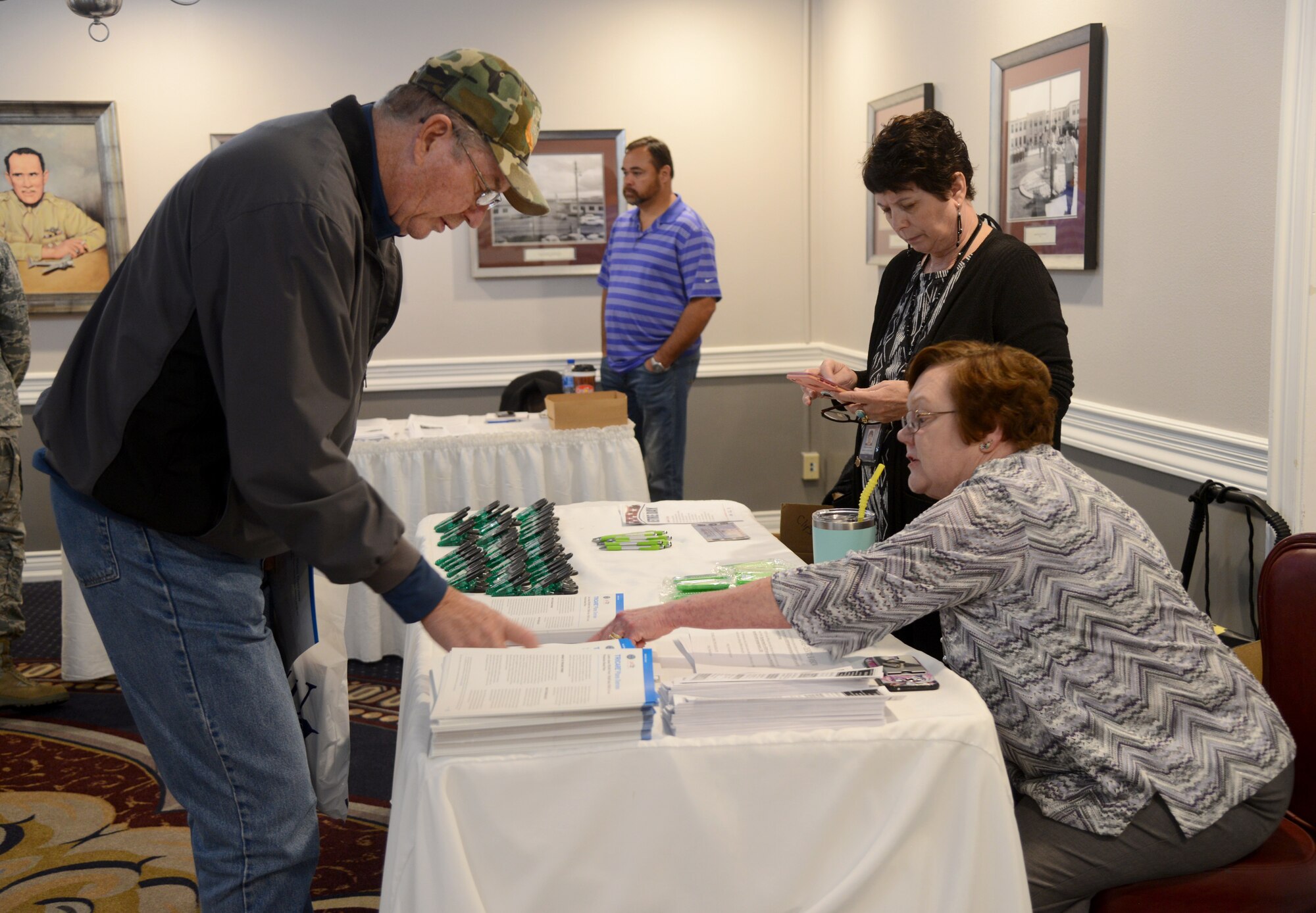 Jerry Shurley receives TRICARE information from Karen Rein, center, and Sharlene Payne during the Retiree Appreciation Day Nov. 3 at the Tinker Club.
