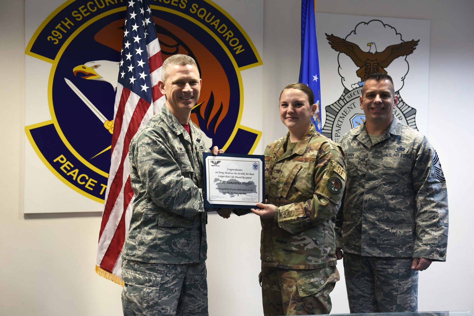 U.S. Air Force Airman 1st Class Samatha Hepfer holds up her Larger Than Life Award at Incirlik Air Base, Turkey.