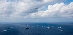 PHILIPPINE SEA (Nov. 8, 2018)The aircraft carrier USS Ronald Reagan (CVN 76), left, and the Japanese helicopter destroyer JS Hyuga (DDH 181), right, sail in formation with 16 other ships from the U.S. Navy and Japan Maritime Self-Defense Force (JMSDF) as aircraft from the U.S. Air Force and Japan Air Self-Defense Force fly overhead in formation during Keen Sword 2019. Keen Sword 2019 is a joint, bilateral field-training exercise involving U.S. military and JMSDF personnel, designed to increase combat readiness and interoperability of the Japan-U.S. alliance.